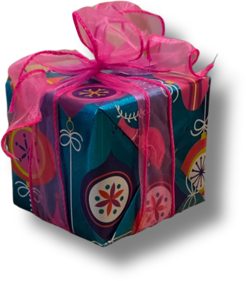 A cube parcel in teal and pink ornament paper, tied with a wide pink organza bow